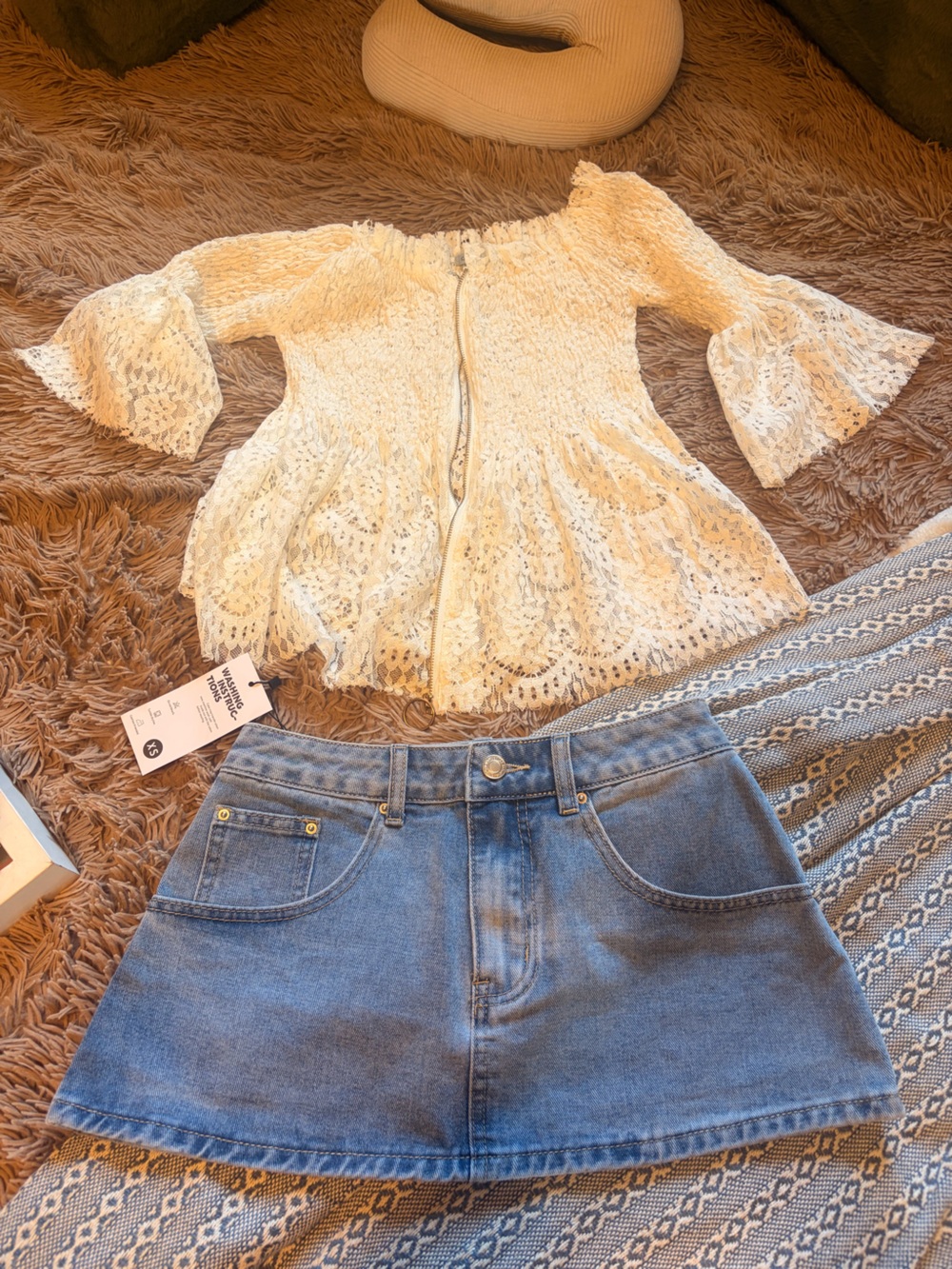 Women’s outfit. Mini denim skirt and a off the shoulder white top, good material